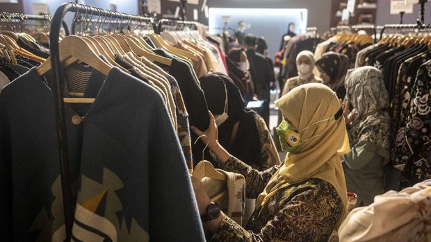 Pengunjung melihat busana yang dijajakan di salah satu stan pameran produk fesyen Muslim Fashion Festival (MUFFEST+) 2023 di Jakarta, Selasa (7/3/2023). Pameran yang diikuti sekitar 150 merek lokal itu menampilkan beragam koleksi produk dari perancang dan pengusaha mode Indonesia dan bertujuan mempromosikan produk fesyen nasional dan berlangsung hingga 10 Maret 2023. ANTARA FOTO/Aprillio Akbar/YU