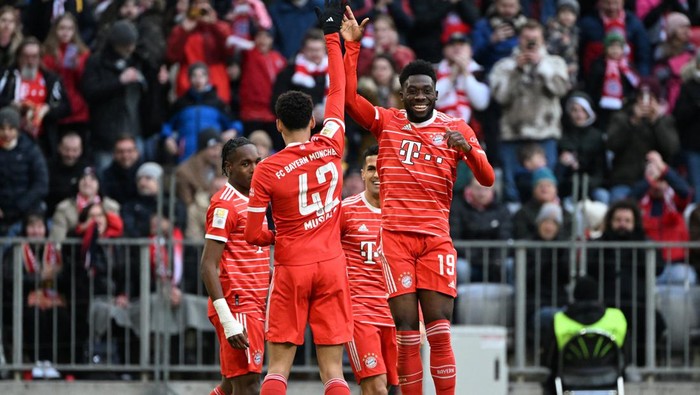 Soccer Football - Bundesliga - Bayern Munich v FC Augsburg - Allianz Arena, Munich, Germany - March 11, 2023 Bayern Munichs Alphonso Davies celebrates scoring their fifth goal with Jamal Musiala REUTERS/Angelika Warmuth DFL REGULATIONS PROHIBIT ANY USE OF PHOTOGRAPHS AS IMAGE SEQUENCES AND/OR QUASI-VIDEO.