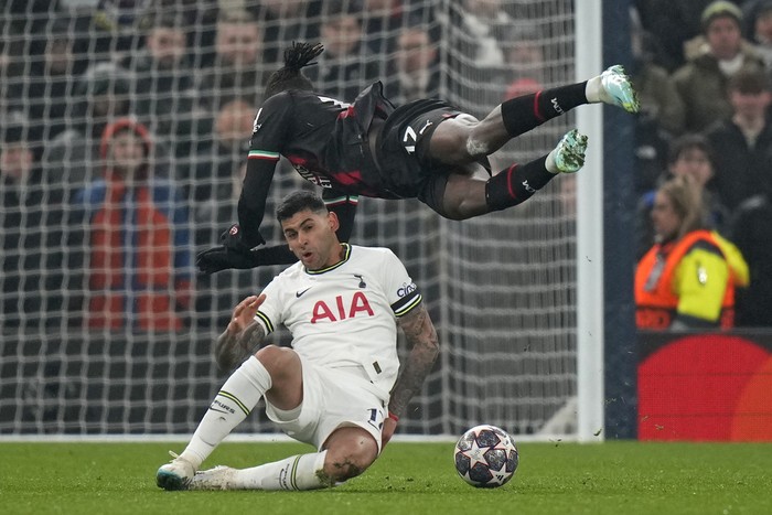 Tottenhams Cristian Romero, bottom, fouls AC Milans Rafael Leao during the Champions League round of 16 second leg soccer match between Tottenham Hotspur and AC Milan at the Tottenham Hotspur stadium in London, Wednesday, March 8, 2023. (AP Photo/Alastair Grant)
