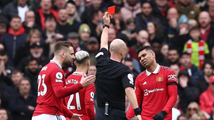 Manchester Uniteds Brazilian midfielder Casemiro (R) reacts after being shown a red card by English referee Anthony Taylor during the English Premier League football match between Manchester United and Southampton at Old Trafford in Manchester, north-west England, on March 12, 2023. (Photo by Darren Staples / AFP) / RESTRICTED TO EDITORIAL USE. No use with unauthorized audio, video, data, fixture lists, club/league logos or live services. Online in-match use limited to 120 images. An additional 40 images may be used in extra time. No video emulation. Social media in-match use limited to 120 images. An additional 40 images may be used in extra time. No use in betting publications, games or single club/league/player publications. /  (Photo by DARREN STAPLES/AFP via Getty Images)