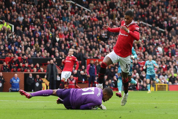 Soccer Football - Premier League - Manchester United v Southampton - Old Trafford, Manchester, Britain - March 12, 2023 Southamptons Gavin Bazunu in action with Manchester Uniteds Marcus Rashford REUTERS/Phil Noble EDITORIAL USE ONLY. No use with unauthorized audio, video, data, fixture lists, club/league logos or live services. Online in-match use limited to 75 images, no video emulation. No use in betting, games or single club /league/player publications.  Please contact your account representative for further details.