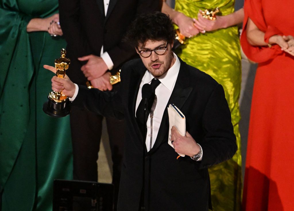 Canadian filmmaker Daniel Roher (C) accepts the Oscar for Best documentary feature film for 