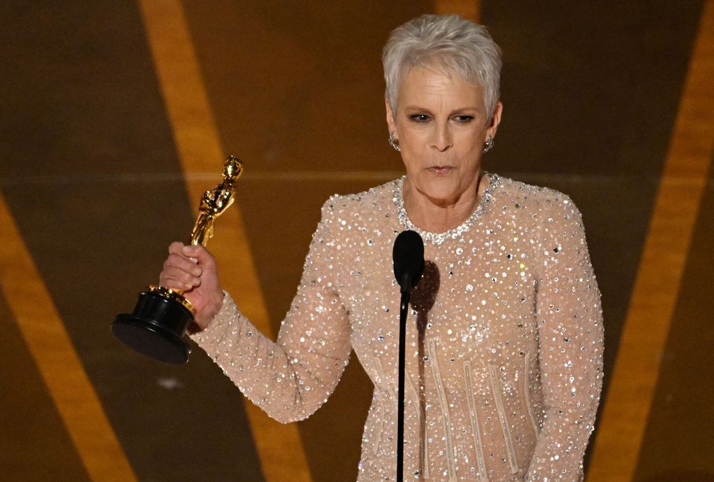 US actress Jamie Lee Curtis accepts the Oscar for Best Actress in a Supporting Role for 