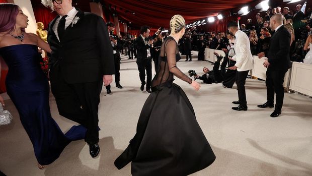 Lady Gaga and BloodPop react on the champagne-colored red carpet during the Oscars arrivals at the 95th Academy Awards in Hollywood, Los Angeles, California, U.S., March 12, 2023. REUTERS/Mario Anzuoni     TPX IMAGES OF THE DAY