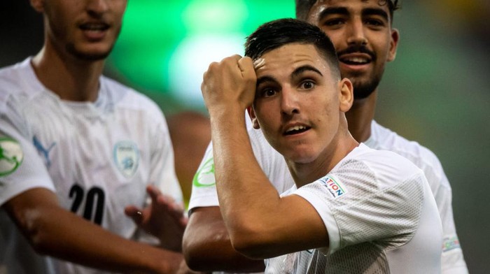 Israels midfielder Oscar Gloukh celebrates scoring the opening goal with his teammates during the UEFA Under-19 European Championship semi-final football match between France and Israel at the DAC Arena in Dunajska Streda, Slovakia on June 28, 2022. (Photo by VLADIMIR SIMICEK / AFP) (Photo by VLADIMIR SIMICEK/AFP via Getty Images)