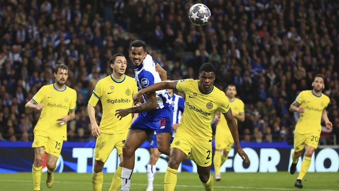 Porto's Galeno, center, jumps for the ball nest to Inter Milan's Denzel Dumfries during the Champions League round of 16, 2nd leg, soccer match between FC Porto and Inter Milan at the Dragao stadium in Porto, Portugal, Tuesday, March 14, 2023. (AP Photo/Luis Vieira)