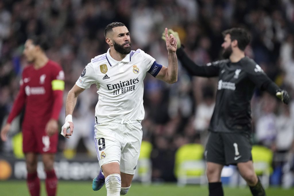 Real Madrid's Karim Benzema celebrates after scoring his sides first goal during the Champions League, round of 16, second leg soccer match between Real Madrid and Liverpool at the Santiago Bernabeu stadium in Madrid, Spain, Wednesday, March 15, 2023. (AP Photo/Bernat Armangue)