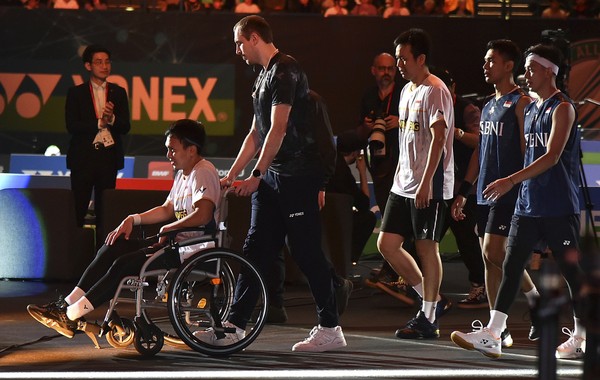 Mohammad Ahsan Mohammad Ahsan attends the podium in a wheelchair after an injury during the mens double final match against Indonesias Indonesias Fajar Alfian and Muhammad Rian Ardinanto in the All England Open Badminton Championships at the Utilita Arena in Birmingham, England, Sunday, March 19, 2023. (AP Photo/Rui Vieira)