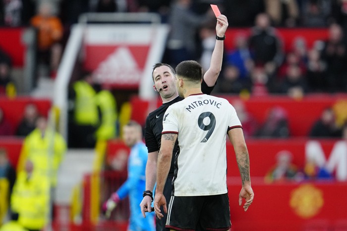 Fulhams Aleksandar Mitrovic is shown red card during the English FA Cup quarterfinal soccer match between Manchester United and Fulham at the Old Trafford stadium in Manchester, England, Sunday, March 19, 2023. (AP Photo/Jon Super)