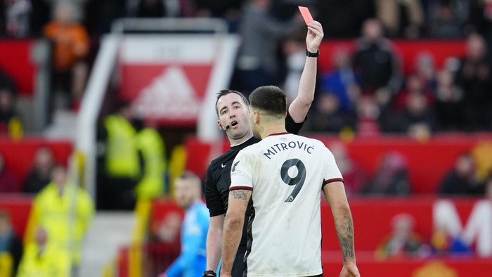 Fulhams Aleksandar Mitrovic is shown red card during the English FA Cup quarterfinal soccer match between Manchester United and Fulham at the Old Trafford stadium in Manchester, England, Sunday, March 19, 2023. (AP Photo/Jon Super)