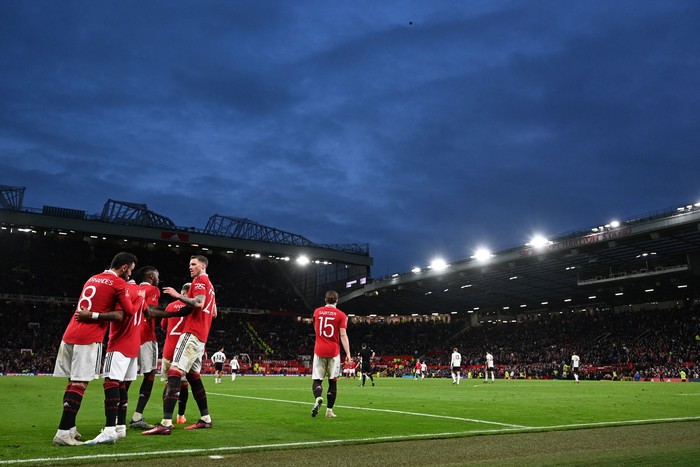 Manchester Uniteds Portuguese midfielder Bruno Fernandes (L) celebrates with teammates after scoring their third goal during the English FA Cup quarter-final football match between Manchester United and Fulham at Old Trafford in Manchester, north-west England, on March 19, 2023. - Man Utd won the game 3-1. (Photo by Paul ELLIS / AFP) / RESTRICTED TO EDITORIAL USE. No use with unauthorized audio, video, data, fixture lists, club/league logos or live services. Online in-match use limited to 120 images. An additional 40 images may be used in extra time. No video emulation. Social media in-match use limited to 120 images. An additional 40 images may be used in extra time. No use in betting publications, games or single club/league/player publications. /  (Photo by PAUL ELLIS/AFP via Getty Images)