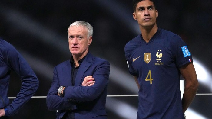 France manager Didier Deschamps (left) and Raphael Varane looks dejected following defeat against Argentina via a penalty shootout in the FIFA World Cup Final match at the Lusail Stadium in Lusail, Qatar. Picture date: Sunday December 18, 2022. (Photo by Martin Rickett/PA Images via Getty Images)
