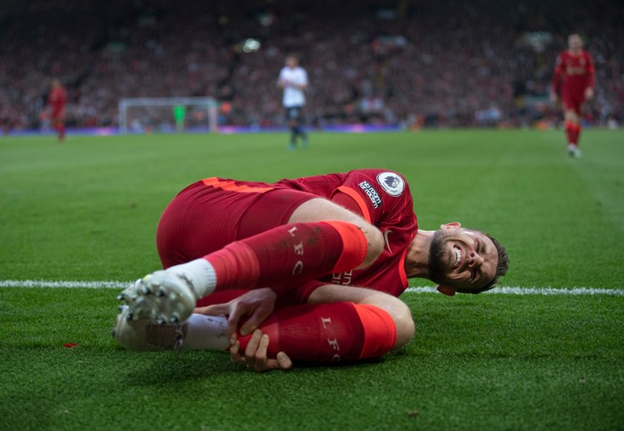 LIVERPOOL, ENGLAND - MAY 07: Jordan Henderson of Liverpool lies injured during the Premier League match between Liverpool and Tottenham Hotspur at Anfield on May 7, 2022 in Liverpool, United Kingdom. (Photo by Visionhaus/Getty Images)