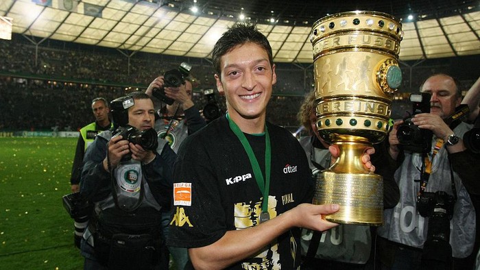 Mesut Oezil Mesut Oezil with the trophy after Bremen won the German DFB Cup finals 1-0 due to his goal (Photo by sampics/Corbis via Getty Images)