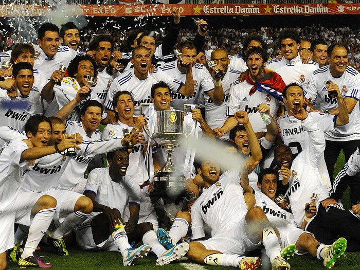 Real Madrid's players celebrate with the trophy after winning the Spanish Cup final match Real Madrid against Barcelona at the Mestalla stadium in Valencia on April 20, 2011. Real Madrid won 1-0.    AFP PHOTO / LLUIS GENE (Photo credit should read LLUIS GENE/AFP via Getty Images)