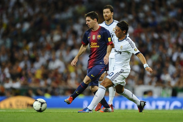 MADRID, SPAIN - AUGUST 29:  Lionel Messi of FC Barcelona (L) duels for the ball with Mesut Ozil of Real Madrid CF during the Super Cup second leg match betwen Real Madrid and FC Barcelona at Estadio Santiago Bernabeu on August 29, 2012 in Madrid, Spain.  (Photo by David Ramos/Getty Images)