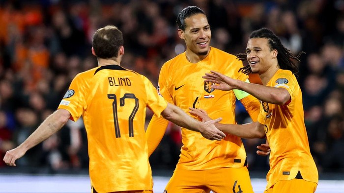 ROTTERDAM, NETHERLANDS - MARCH 27: Nathan Ake of the Netherlands celebrates with Daley Blind of the Netherlands and Virgil van Dijk of the Netherlands after scoring his sides third goal during the UEFA EURO 2024 Qualifying Round Group B match between Netherlands and Gibraltar at Stadion Feijenoord on March 27, 2023 in Rotterdam, Netherlands (Photo by Peter Lous/BSR Agency/Getty Images)