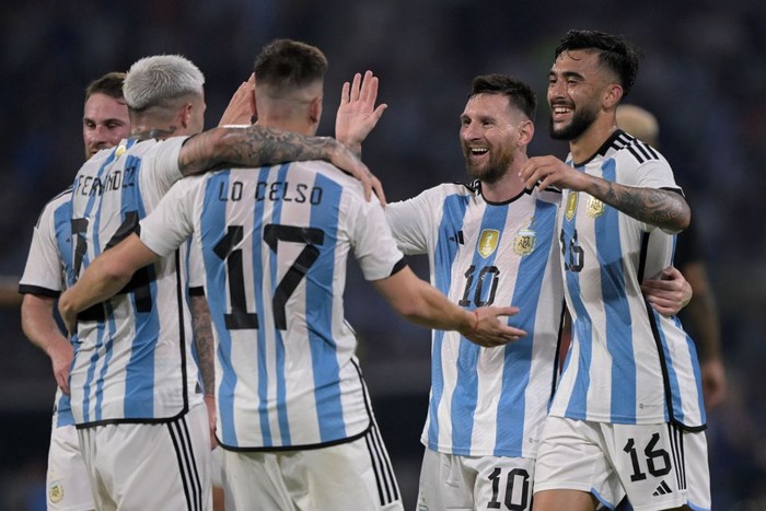 Argentina vs Curacao Argentina's midfielder Enzo Fernandez (L) celebrates with (L to R) midfielder Giovani Lo Celso, forward Lionel Messi and forward Nicolas Gonzalez after scoring against Curacao during the friendly football match between Argentina and Curacao at the Madre de Ciudades stadium in Santiago del Estero, in northern Argentina, on March 28, 2023. (Photo by JUAN MABROMATA / AFP) (Photo by JUAN MABROMATA/AFP via Getty Images)