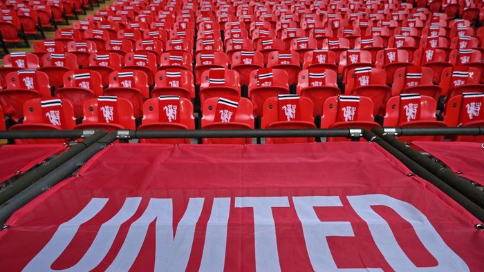 Manchester United-branded scarves and flags are pictured in the stands ahead of the English League Cup final football match between Manchester United and Newcastle United at Wembley Stadium, north-west London on February 26, 2023. (Photo by Glyn KIRK / AFP) / RESTRICTED TO EDITORIAL USE. No use with unauthorized audio, video, data, fixture lists, club/league logos or live services. Online in-match use limited to 120 images. An additional 40 images may be used in extra time. No video emulation. Social media in-match use limited to 120 images. An additional 40 images may be used in extra time. No use in betting publications, games or single club/league/player publications. /  (Photo by GLYN KIRK/AFP via Getty Images)