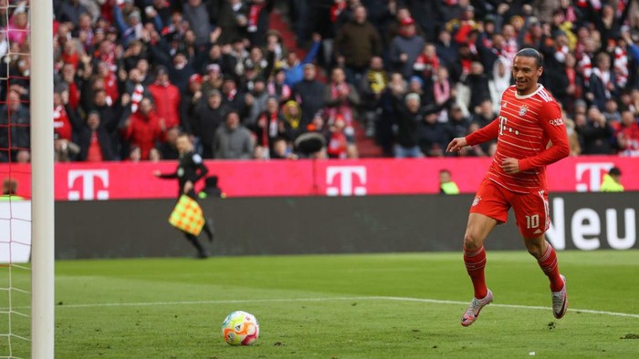 MUNICH, GERMANY - APRIL 01: Leroy Sane of FC Bayern Munich reacts as the ball rolls into the net for their team's first goal, an own goal scored by Gregor Kobel (not pictured) of Borussia Dortmund during the Bundesliga match between FC Bayern München and Borussia Dortmund at Allianz Arena on April 01, 2023 in Munich, Germany. (Photo by Lars Baron/Getty Images)