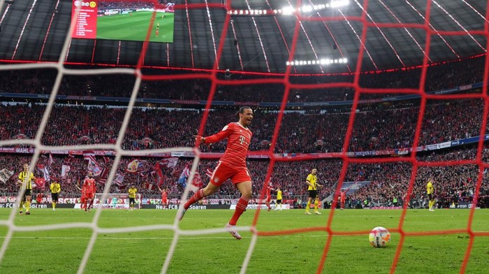 MUNICH, GERMANY - APRIL 01: Leroy Sane of FC Bayern Munich celebrates their team's first goal, an own goal scored by Gregor Kobel (not pictured) of Borussia Dortmund during the Bundesliga match between FC Bayern München and Borussia Dortmund at Allianz Arena on April 01, 2023 in Munich, Germany. (Photo by Lars Baron/Getty Images)