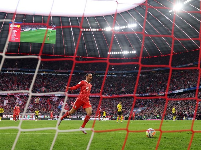 MUNICH, GERMANY - APRIL 01: Leroy Sane of FC Bayern Munich celebrates their team's first goal, an own goal scored by Gregor Kobel (not pictured) of Borussia Dortmund during the Bundesliga match between FC Bayern München and Borussia Dortmund at Allianz Arena on April 01, 2023 in Munich, Germany. (Photo by Lars Baron/Getty Images)