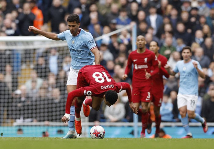 Soccer Football - Premier League - Manchester City v Liverpool - Etihad Stadium, Manchester, Britain - April 1, 2023  Manchester Citys Rodri in action with Liverpools Cody Gakpo Action Images via Reuters/Jason Cairnduff EDITORIAL USE ONLY. No use with unauthorized audio, video, data, fixture lists, club/league logos or live services. Online in-match use limited to 75 images, no video emulation. No use in betting, games or single club /league/player publications.  Please contact your account representative for further details.