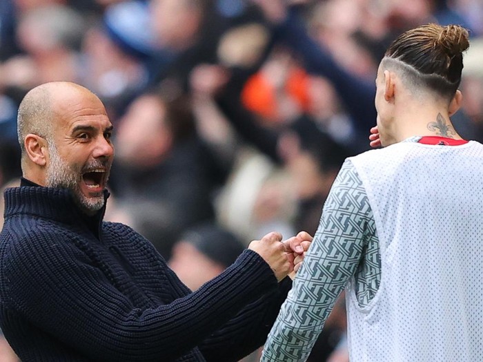 MANCHESTER, ENGLAND - APRIL 01: Josep 'Pep' Guardiola, manager of Manchester City, taunts Kostas Tsimikas of Liverpool as he celebrates his side's first goal during the Premier League match between Manchester City and Liverpool FC at Etihad Stadium on April 01, 2023 in Manchester, England. (Photo by James Gill - Danehouse/Getty Images)