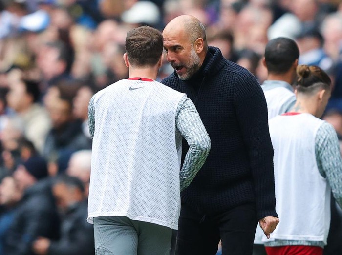 MANCHESTER, ENGLAND - APRIL 01: Josep 'Pep' Guardiola, manager of Manchester City, taunts Arthur Melo of Liverpool as he celebrates his side's first goal during the Premier League match between Manchester City and Liverpool FC at Etihad Stadium on April 01, 2023 in Manchester, England. (Photo by James Gill - Danehouse/Getty Images)