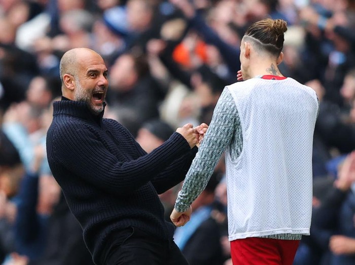 MANCHESTER, ENGLAND - APRIL 01: Josep 'Pep' Guardiola, manager of Manchester City, taunts Kostas Tsimikas of Liverpool as he celebrates his side's first goal during the Premier League match between Manchester City and Liverpool FC at Etihad Stadium on April 01, 2023 in Manchester, England. (Photo by James Gill - Danehouse/Getty Images)