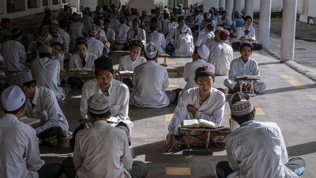 Students learn Islamic scriptures in the Islamic boarding school Al-Fatah Temboro during the holy month of Ramadan on April 02, 2023 in Magetan, East Java, Indonesia. Al-Fatah Islamic Boarding School was founded in 1950 by KH. Kholid Umar, also known as Kyai Mahmud. Islamic boarding schools in Indonesia have around 22,000 students, including those from neighboring countries in Southeast Asia, such as Malaysia, Brunei, and Thailand. The Al-Falah boarding school occupies a 50-hectare site in Temboro Village, Karas District, Magetan, East Java. It is the largest center for developing the ideology of the Tablighi Jamaat in Southeast Asia. The main goal of the Al-Fatah Islamic Boarding School is to learn about the Prophet, produce religious experts, spread Islam to all walks of life, improve oneself and uphold the da'wah journey of Allah's Apostle. The school's magnitude of the influence of religion on the lives of residents in Temboro has made this area known as the 'Village of Medina'. Students at the Pesantren, also known as 