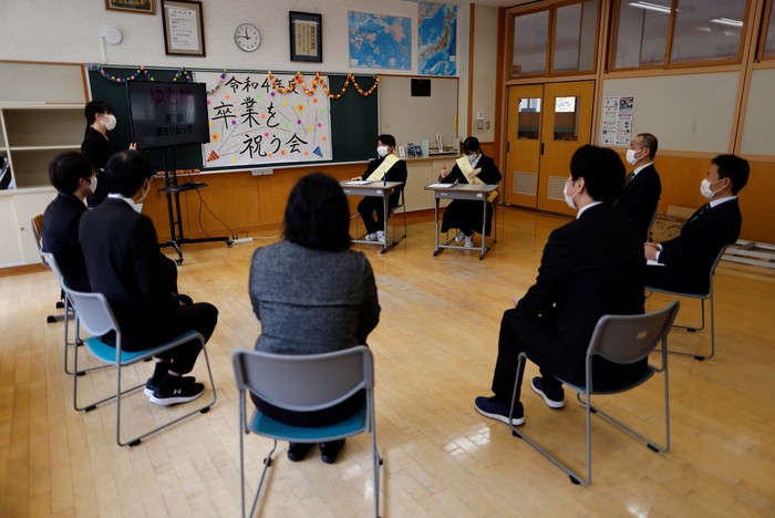 Eita Sato, 15, and Aoi Hoshi, 15, who are the only two students at Yumoto Junior High School, attend a Japanese traditional calligraphy class to write a message that will be engraved into the school's closing memorial stone, a few days before their graduation and the institution's closing ceremony, in Ten-ei Village, Fukushima Prefecture, Japan, March 9, 2023. Eita and Aoi, who have been together since three, are the last two graduates of Yumoto Junior High, a public school established in 1947 that in its prosperous years sent out more than 50 graduates, but with only a few enrolments expected in the coming years, the village decided to close the school for good. 