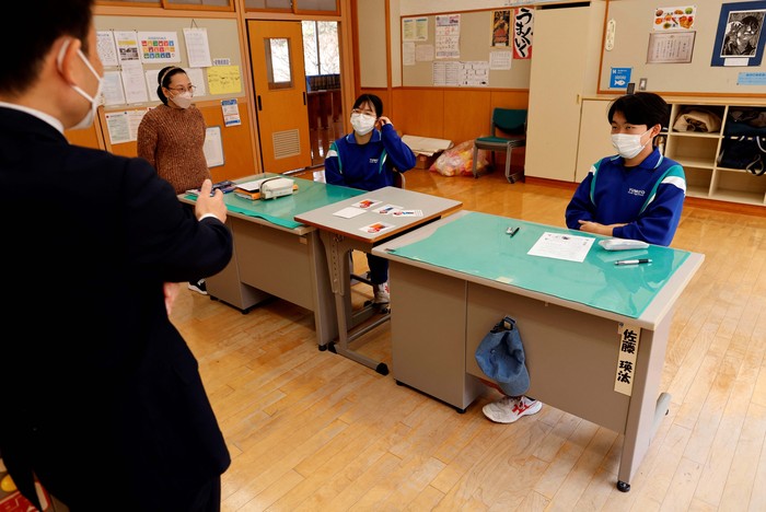 Eita Sato, 15, and Aoi Hoshi, 15, who are the only two students at Yumoto Junior High School, attend a Japanese traditional calligraphy class to write a message that will be engraved into the school's closing memorial stone, a few days before their graduation and the institution's closing ceremony, in Ten-ei Village, Fukushima Prefecture, Japan, March 9, 2023. Eita and Aoi, who have been together since three, are the last two graduates of Yumoto Junior High, a public school established in 1947 that in its prosperous years sent out more than 50 graduates, but with only a few enrolments expected in the coming years, the village decided to close the school for good. 