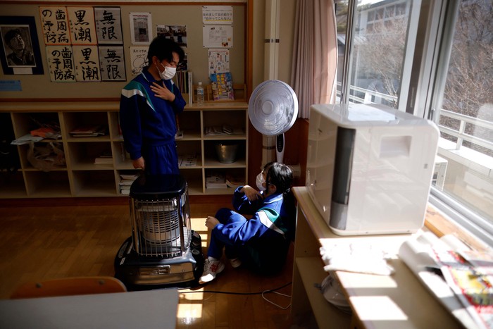 Eita Sato, 15, and Aoi Hoshi, 15, who are the only two students at Yumoto Junior High School, attend a Japanese traditional calligraphy class to write a message that will be engraved into the school's closing memorial stone, a few days before their graduation and the institution's closing ceremony, in Ten-ei Village, Fukushima Prefecture, Japan, March 9, 2023. Eita and Aoi, who have been together since three, are the last two graduates of Yumoto Junior High, a public school established in 1947 that in its prosperous years sent out more than 50 graduates, but with only a few enrolments expected in the coming years, the village decided to close the school for good. 