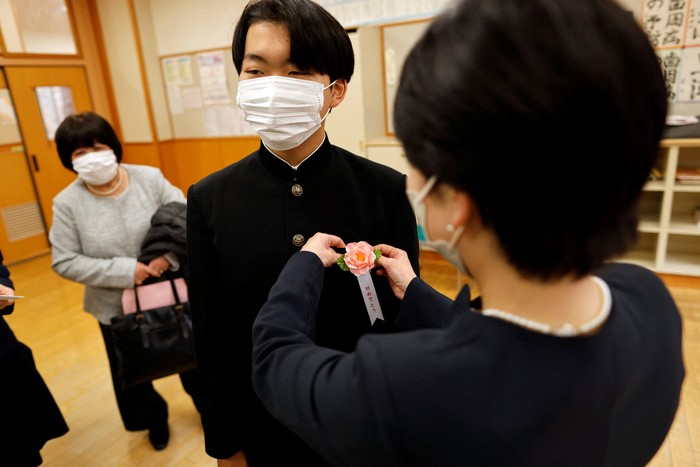 Eita Sato, 15, and Aoi Hoshi, 15, who are the only two students at Yumoto Junior High School, attend a Japanese traditional calligraphy class to write a message that will be engraved into the school's closing memorial stone, a few days before their graduation and the institution's closing ceremony, in Ten-ei Village, Fukushima Prefecture, Japan, March 9, 2023. Eita and Aoi, who have been together since three, are the last two graduates of Yumoto Junior High, a public school established in 1947 that in its prosperous years sent out more than 50 graduates, but with only a few enrolments expected in the coming years, the village decided to close the school for good. 