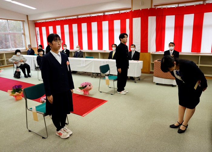 Eita Sato, 15, and Aoi Hoshi, 15, who are the only two students at Yumoto Junior High School, attend a Japanese traditional calligraphy class to write a message that will be engraved into the school's closing memorial stone, a few days before their graduation and the institution's closing ceremony, in Ten-ei Village, Fukushima Prefecture, Japan, March 9, 2023. Eita and Aoi, who have been together since three, are the last two graduates of Yumoto Junior High, a public school established in 1947 that in its prosperous years sent out more than 50 graduates, but with only a few enrolments expected in the coming years, the village decided to close the school for good. 