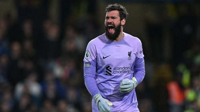 Liverpools Brazilian goalkeeper Alisson Becker gestures during the English Premier League football match between Chelsea and Liverpool at Stamford Bridge in London on April 4, 2023. (Photo by Glyn KIRK / AFP) / RESTRICTED TO EDITORIAL USE. No use with unauthorized audio, video, data, fixture lists, club/league logos or live services. Online in-match use limited to 120 images. An additional 40 images may be used in extra time. No video emulation. Social media in-match use limited to 120 images. An additional 40 images may be used in extra time. No use in betting publications, games or single club/league/player publications. /  (Photo by GLYN KIRK/AFP via Getty Images)