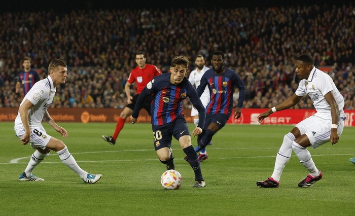 Soccer Football - Copa del Rey - Semi Final - Second Leg - FC Barcelona v Real Madrid - Camp Nou, Barcelona, Spain - April 5, 2023 FC Barcelonas Gavi in action with Real Madrids David Alaba REUTERS/Albert Gea