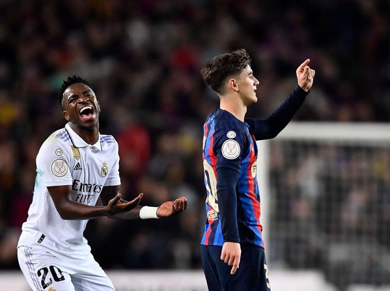 Real Madrid's Brazilian forward Vinicius Junior (L) and Barcelona's Spanish midfielder Gavi gesture during the Copa del Rey (King's Cup) semi-final second leg football match between FC Barcelona and Real Madrid CF at the Camp Nou stadium in Barcelona on April 5, 2023. (Photo by Pau BARRENA / AFP) (Photo by PAU BARRENA/AFP via Getty Images)