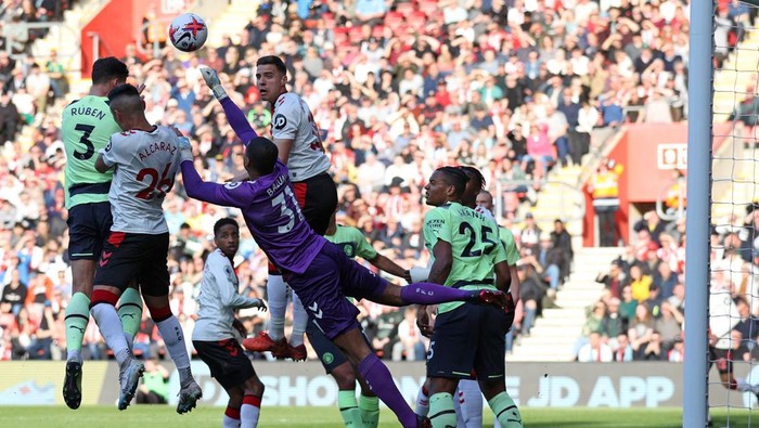 Southamptons Irish goalkeeper Gavin Bazunu punches the ball clear during the English Premier League football match between Southampton and Manchester City at St Marys Stadium in Southampton, southern England on April 8, 2023. (Photo by ADRIAN DENNIS / AFP) / RESTRICTED TO EDITORIAL USE. No use with unauthorized audio, video, data, fixture lists, club/league logos or live services. Online in-match use limited to 120 images. An additional 40 images may be used in extra time. No video emulation. Social media in-match use limited to 120 images. An additional 40 images may be used in extra time. No use in betting publications, games or single club/league/player publications. /  (Photo by ADRIAN DENNIS/AFP via Getty Images)