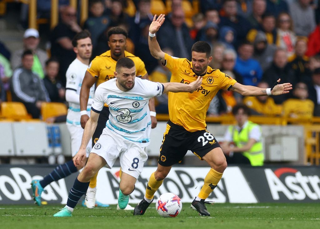 Soccer Football - Premier League - Wolverhampton Wanderers v Chelsea - Molineux Stadium, Wolverhampton, Britain - April 8, 2023 Chelsea's Mateo Kovacic in action with Wolverhampton Wanderers' Joao Moutinho Action Images via Reuters/Paul Childs EDITORIAL USE ONLY. No use with unauthorized audio, video, data, fixture lists, club/league logos or 'live' services. Online in-match use limited to 75 images, no video emulation. No use in betting, games or single club /league/player publications.  Please contact your account representative for further details.