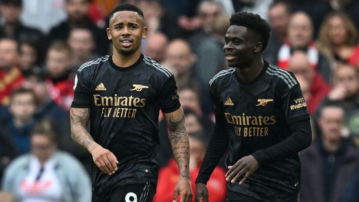 Arsenals Brazilian striker Gabriel Jesus (L) celebrates scoring the teams second goal with Arsenals English midfielder Bukayo Saka during the English Premier League football match between Liverpool and Arsenal at Anfield in Liverpool, north west England on April 9, 2023. (Photo by Paul ELLIS / AFP) / RESTRICTED TO EDITORIAL USE. No use with unauthorized audio, video, data, fixture lists, club/league logos or live services. Online in-match use limited to 120 images. An additional 40 images may be used in extra time. No video emulation. Social media in-match use limited to 120 images. An additional 40 images may be used in extra time. No use in betting publications, games or single club/league/player publications. /  (Photo by PAUL ELLIS/AFP via Getty Images)