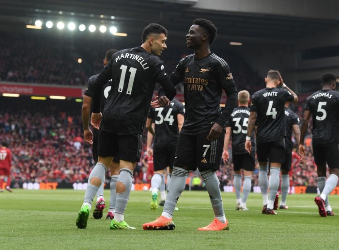 LIVERPOOL, ENGLAND - APRIL 09: (L) Gabriel Martinelli celebrates scoring the 1st Arsenal goal with (R) Bukayo Saka during the Premier League match between Liverpool FC and Arsenal FC at Anfield on April 09, 2023 in Liverpool, England. (Photo by Stuart MacFarlane/Arsenal FC via Getty Images)