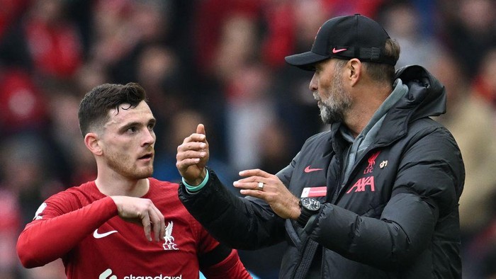 Liverpools German manager Jurgen Klopp (R) gives instructions to Liverpools Scottish defender Andrew Robertson during the English Premier League football match between Liverpool and Arsenal at Anfield in Liverpool, north west England on April 9, 2023. (Photo by Paul ELLIS / AFP) / RESTRICTED TO EDITORIAL USE. No use with unauthorized audio, video, data, fixture lists, club/league logos or live services. Online in-match use limited to 120 images. An additional 40 images may be used in extra time. No video emulation. Social media in-match use limited to 120 images. An additional 40 images may be used in extra time. No use in betting publications, games or single club/league/player publications. /  (Photo by PAUL ELLIS/AFP via Getty Images)