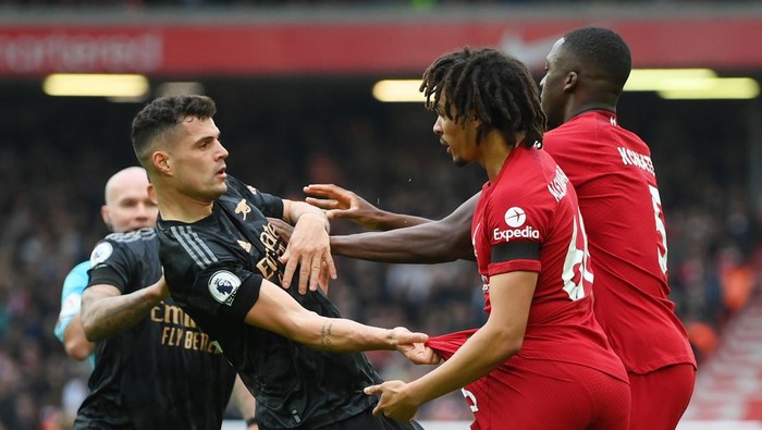 LIVERPOOL, ENGLAND - APRIL 09: Granit Xhaka of Arsenal is confronted by Trent Alexander-Arnold and Ibrahima Konate of Liverpool during the Premier League match between Liverpool FC and Arsenal FC at Anfield on April 09, 2023 in Liverpool, England. (Photo by Shaun Botterill/Getty Images)