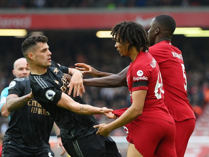 LIVERPOOL, ENGLAND - APRIL 09: Granit Xhaka of Arsenal is confronted by Trent Alexander-Arnold and Ibrahima Konate of Liverpool during the Premier League match between Liverpool FC and Arsenal FC at Anfield on April 09, 2023 in Liverpool, England. (Photo by Shaun Botterill/Getty Images)