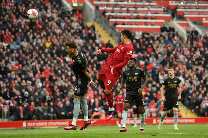 Liverpool vs Arsenal LIVERPOOL, ENGLAND - APRIL 09: Roberto Firmino of Liverpool scores the team's second goal whilst under pressure from Ben White of Arsenal during the Premier League match between Liverpool FC and Arsenal FC at Anfield on April 09, 2023 in Liverpool, England. (Photo by Shaun Botterill/Getty Images)