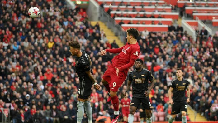 LIVERPOOL, ENGLAND - APRIL 09: Roberto Firmino of Liverpool scores the teams second goal whilst under pressure from Ben White of Arsenal during the Premier League match between Liverpool FC and Arsenal FC at Anfield on April 09, 2023 in Liverpool, England. (Photo by Shaun Botterill/Getty Images)