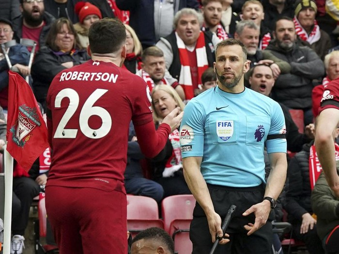 Liverpool's Andrew Robertson appeals to assistant referee Constantine Hatzidakis during the Premier League match between Liverpool and Arsenal at Anfield, Liverpool, Britain, Sunday April 9, 2023. (Nick Potts/PA via AP)
