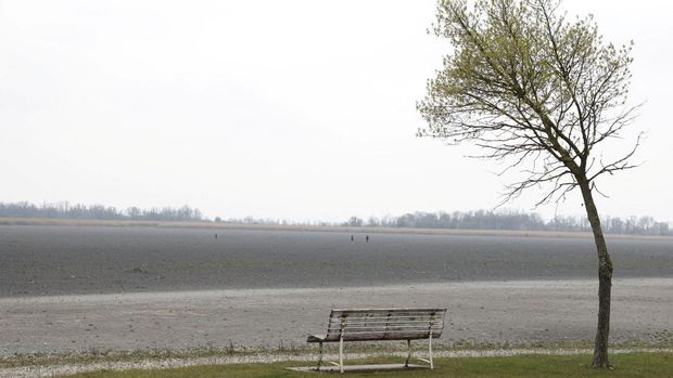 People walk on dried up Lake Zicksee near Sankt Andrae, Austria, April 9, 2023. REUTERS/Leonhard Foeger
